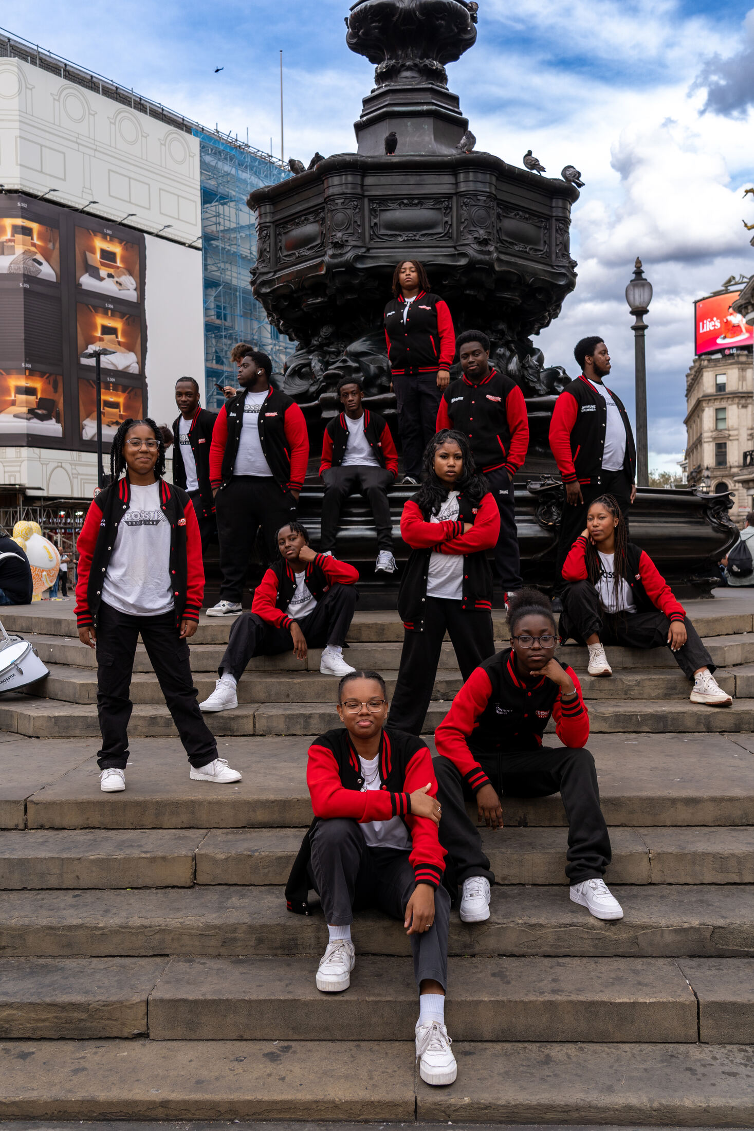 The full CrosStix drumline posed on the steps of the Eros statue, Piccadilly Circus