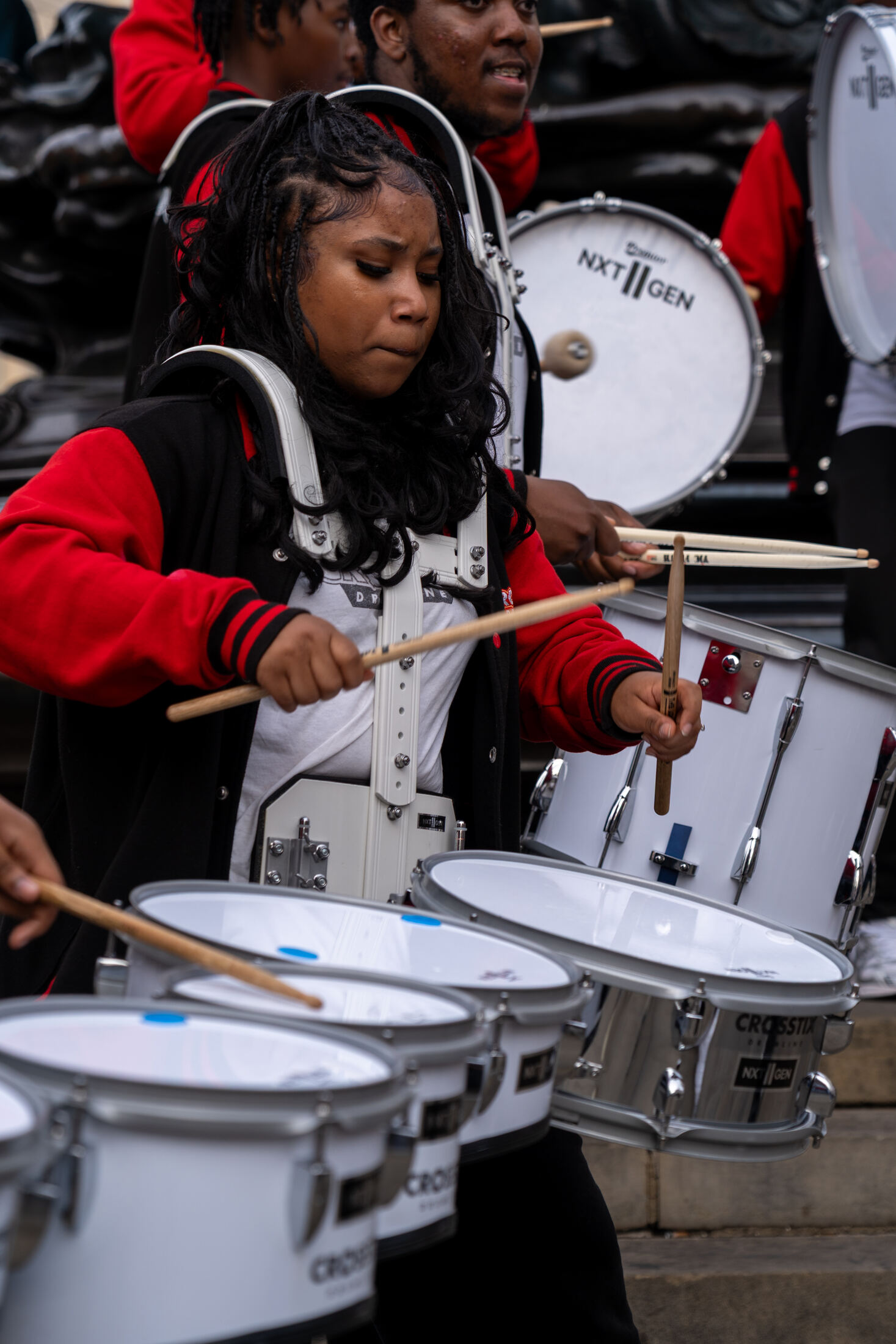 Drummer playing with concentration, sticks raised