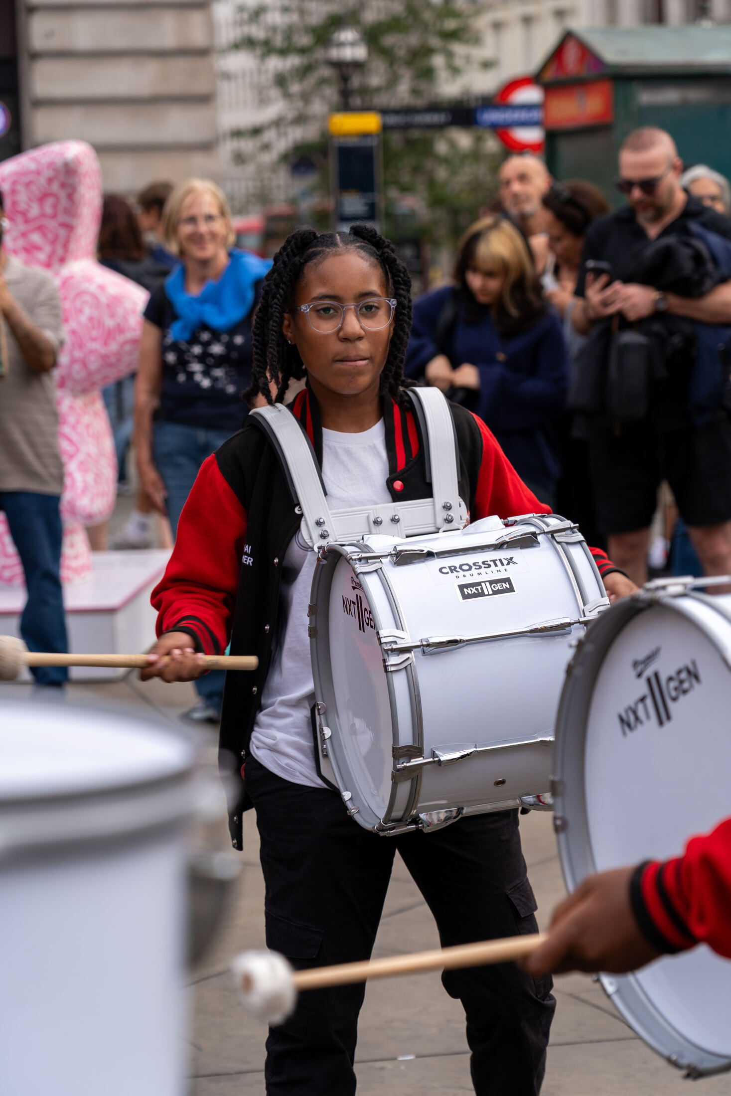 Snare drummer playing in a crowd at Piccadilly Circus